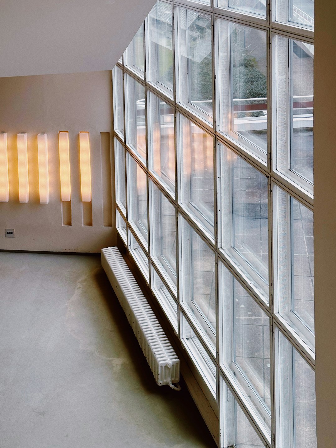 Modern office with floor-to-ceiling windows overlooking a city.