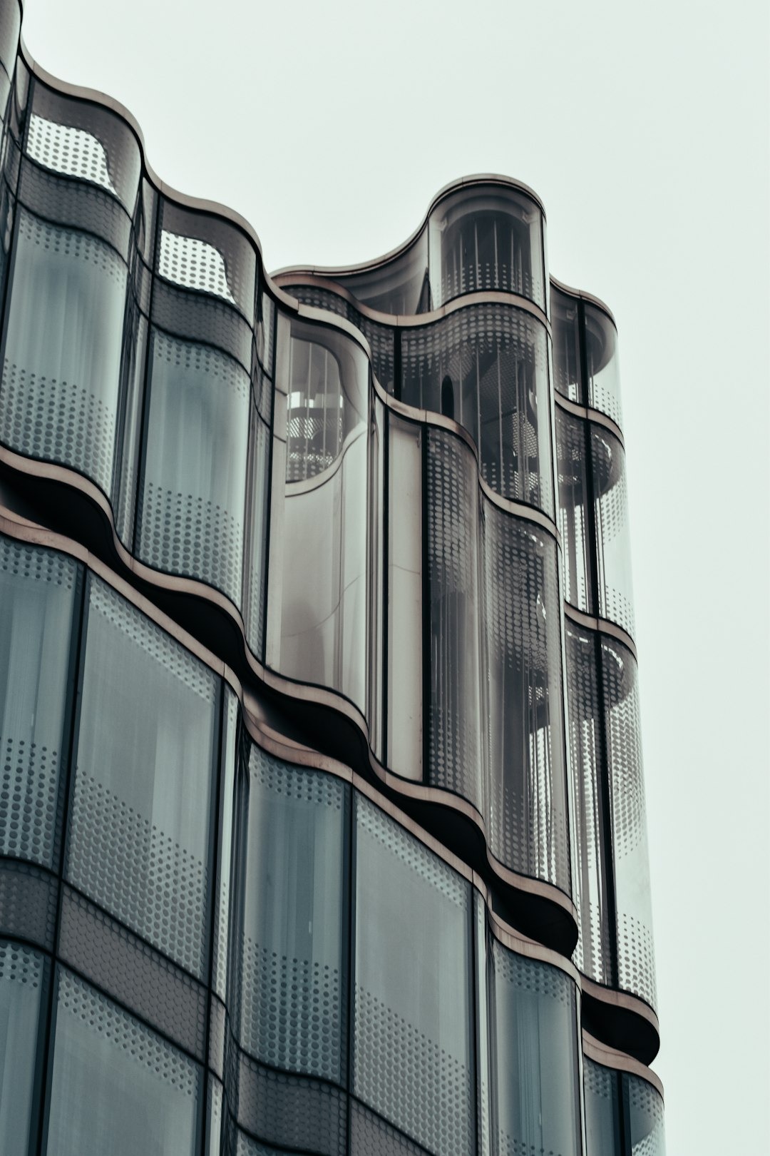 Modern architectural glass panels with wavy grey trim.